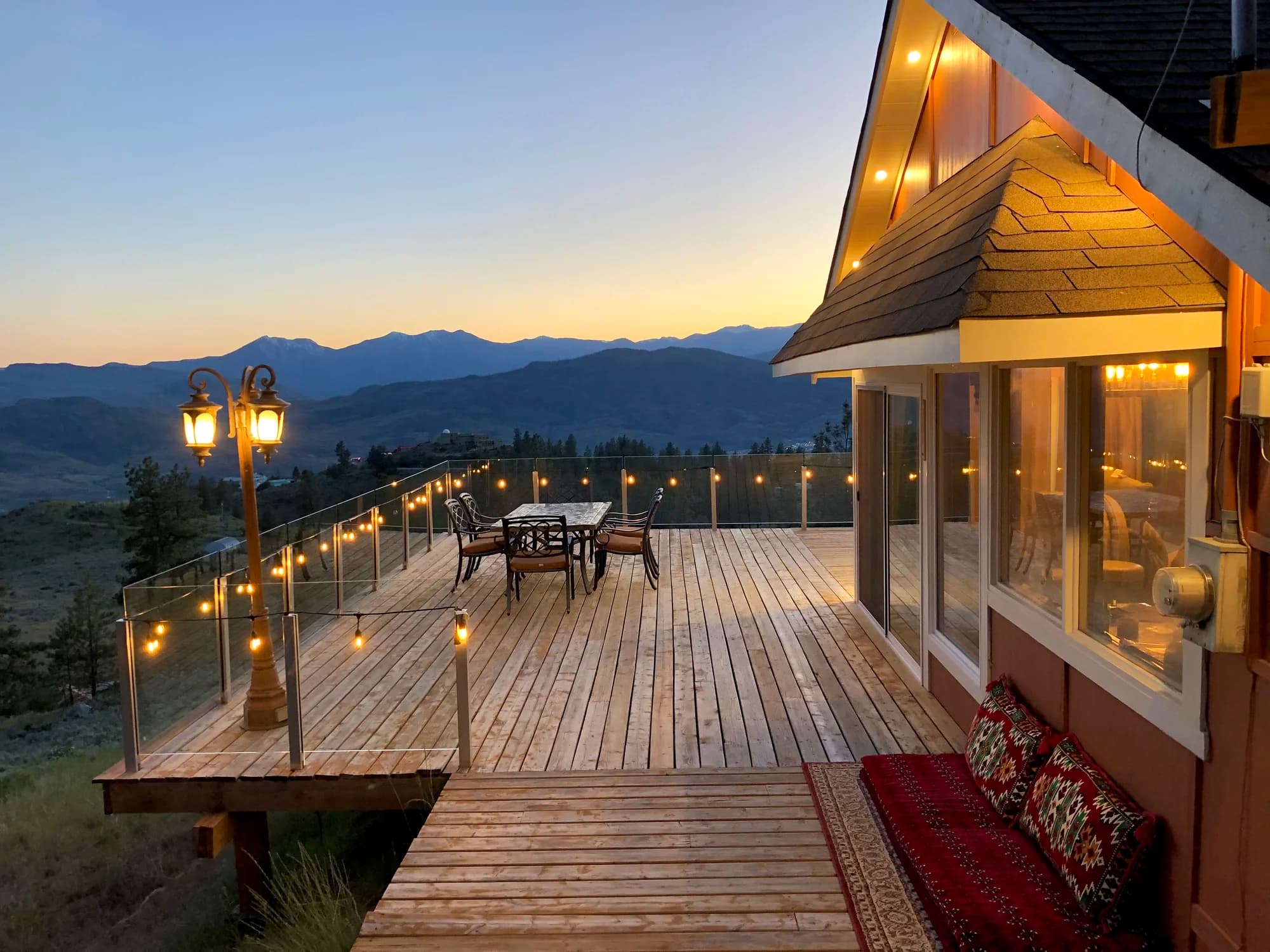Vista Peak deck at sunset with string lights and mountain views