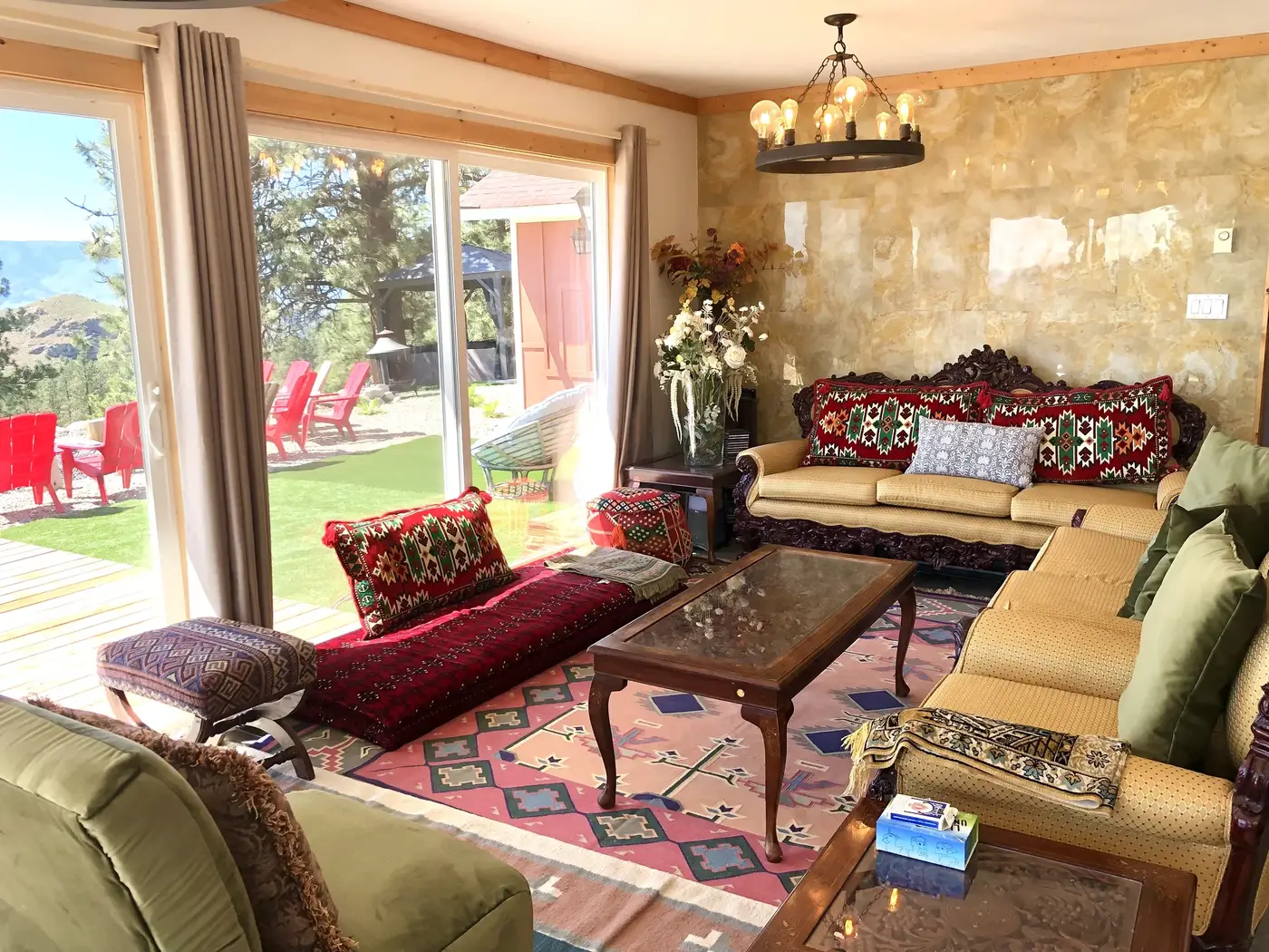 Vista Peak living room textured accent wall with chandelier and colorful eclectic furniture